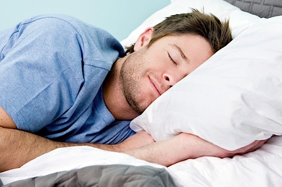 Man comfortably sleeping in his bed - Photo courtesy of ©iStockphoto.com/sswartz, Image #9674561